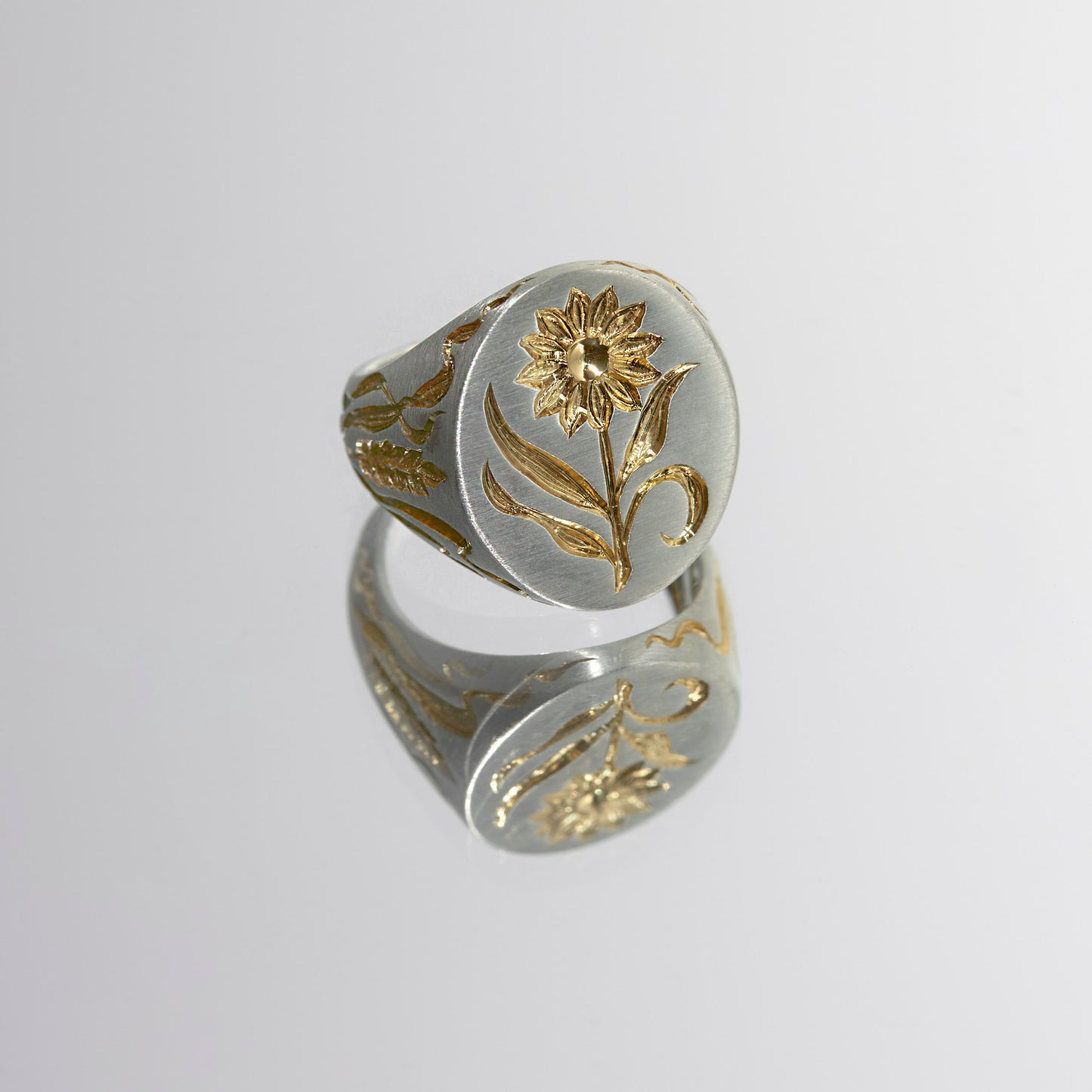Castro Smith - Hand engraved signet ring with a sunflower on the face of the ring and corn details on the sides.