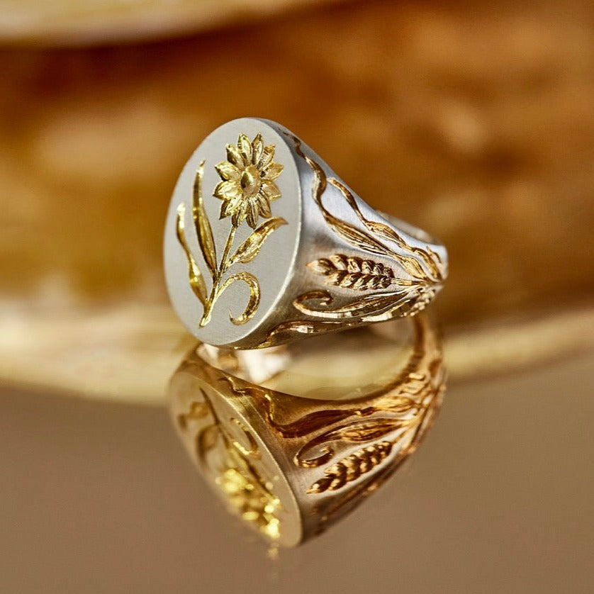 Castro Smith - Hand engraved signet ring with a sunflower on the face of the ring and corn details on the sides.