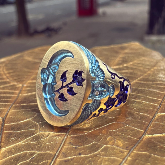 Castro Smith: Gold signet ring with hand engraved moon, flowers and owls set with diamonds and plated in blue colours. 