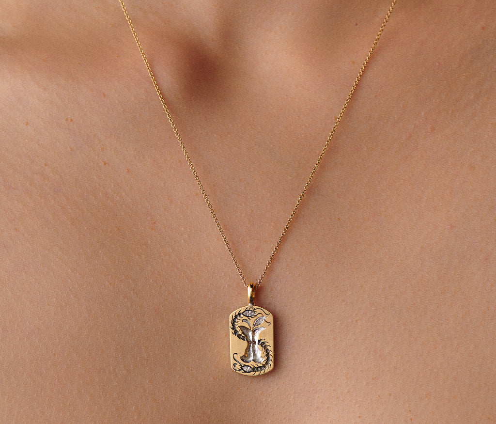 Gold Apple Core pendant necklace with cognac diamond seed and diamond-tipped centipe on a delicate chain