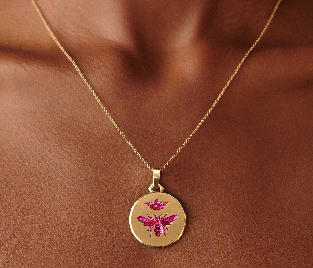 Gold Queen Bee Pendant necklace featuring a hand-engraved bee with a crown, worn on a delicate chain.