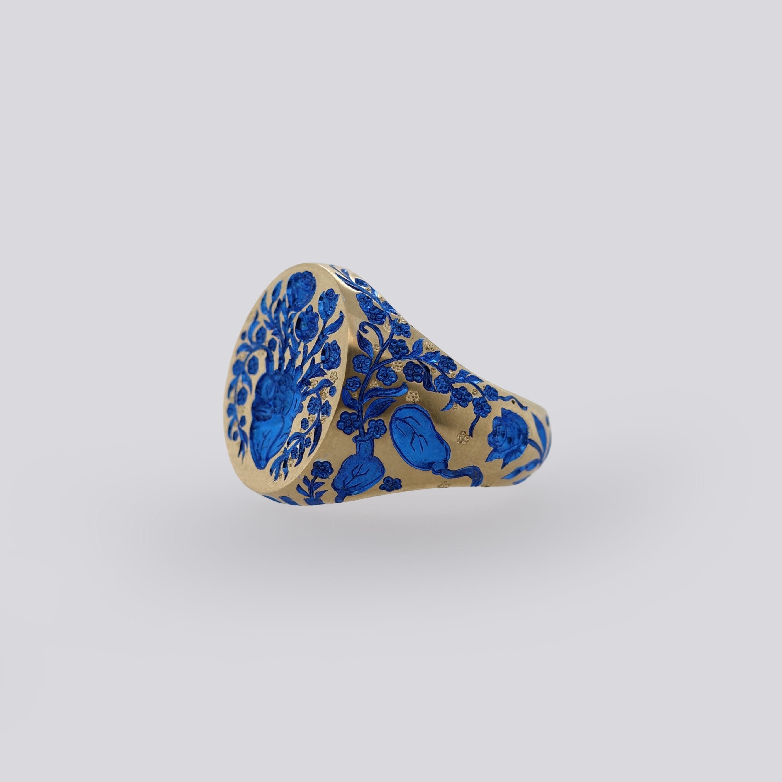 Yellow gold Heart Signet ring with intricate blue floral designs symbolizing healing and classic elegance.