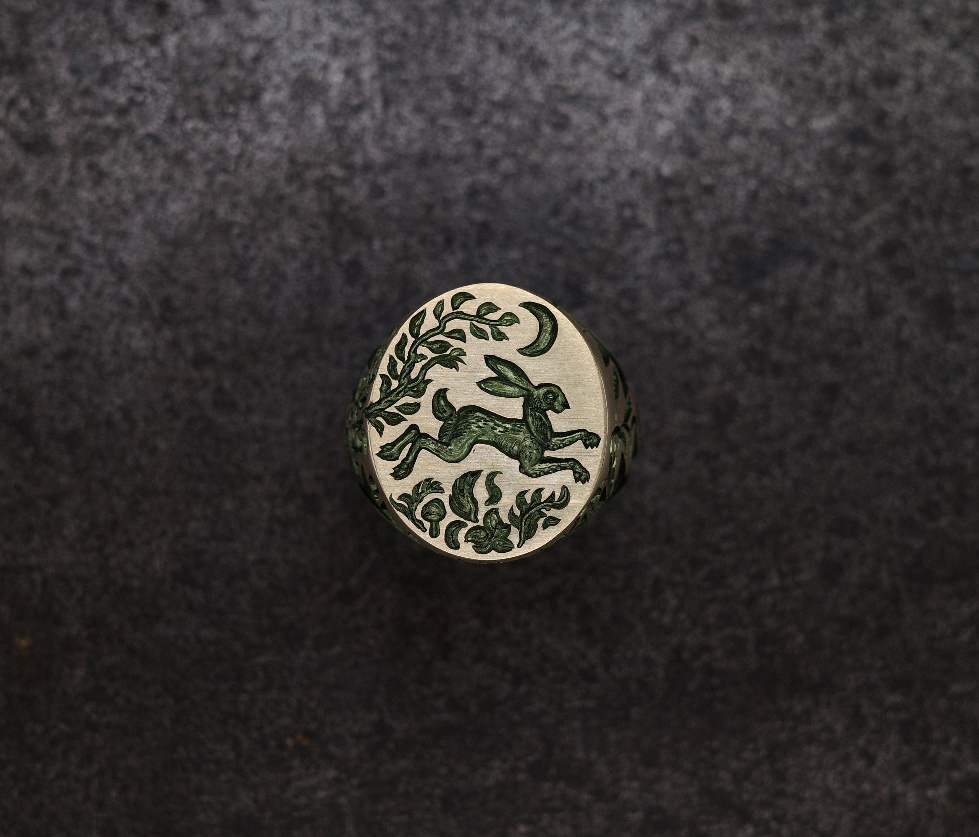 Hand engraved Hare & Trap signet ring in silver with blue detailing of a hare escaping under the moon and floral motifs