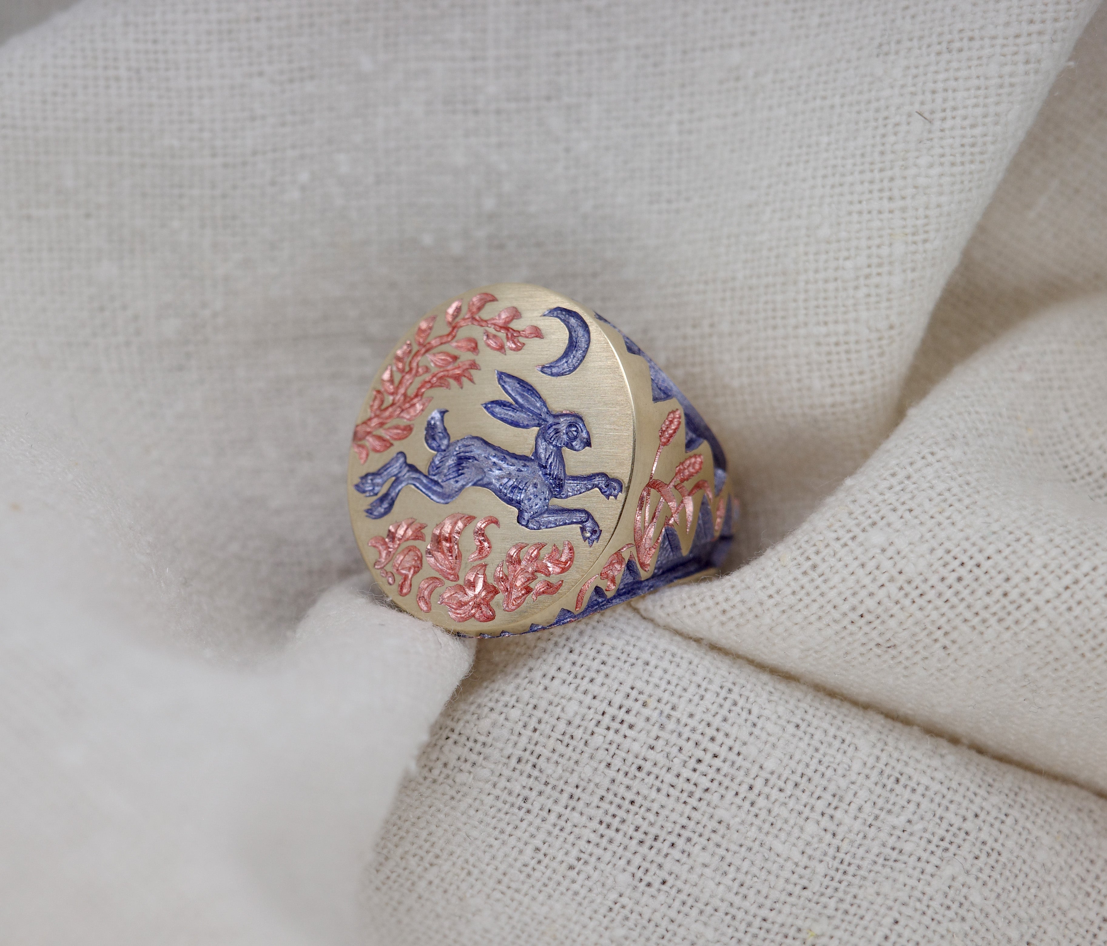 Hand engraved Hare & Trap signet ring in silver with blue detailing of a hare escaping under the moon and floral motifs