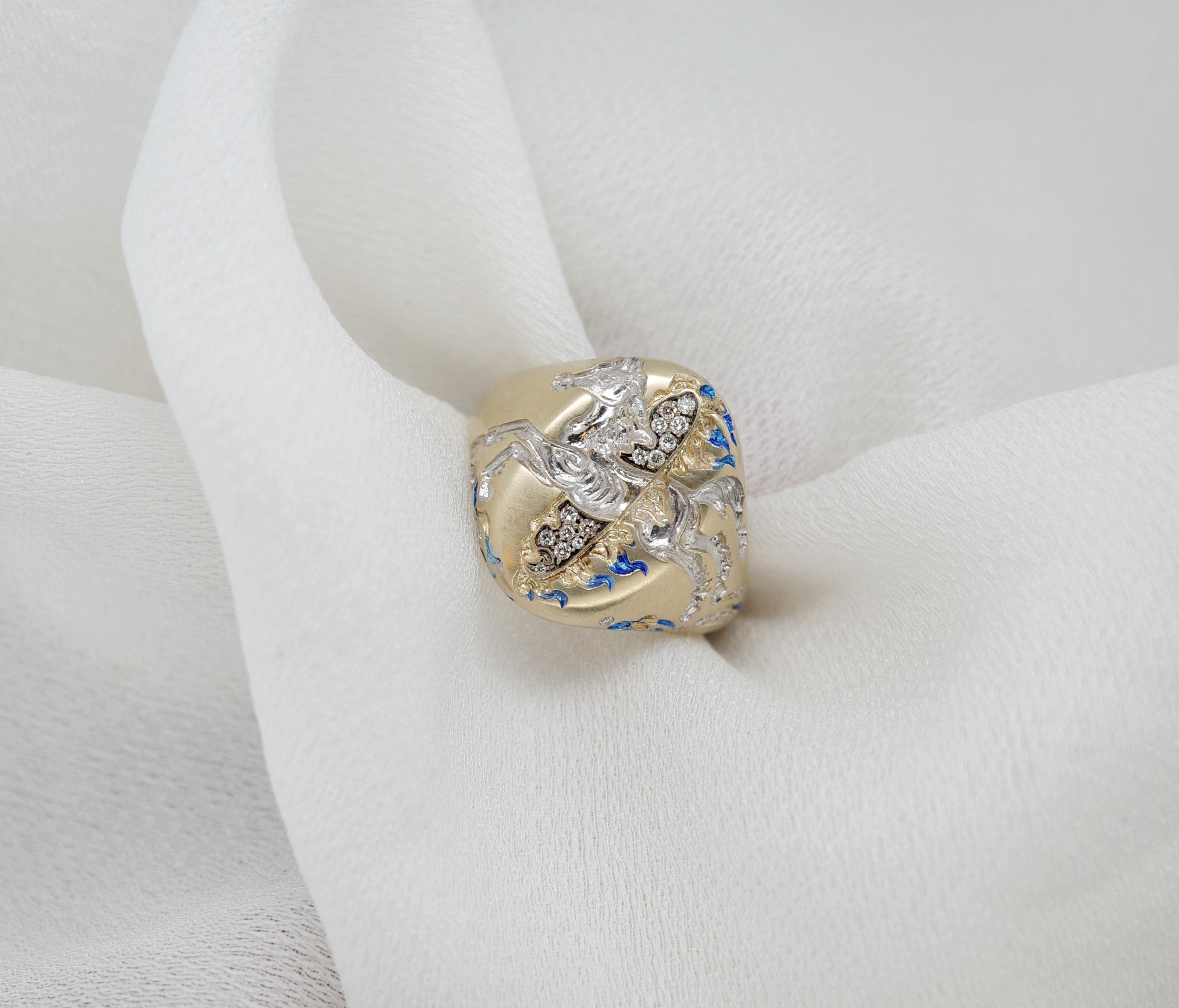 Fire Horse Ring showcased on soft white fabric with intricate detailing and shimmering accents.