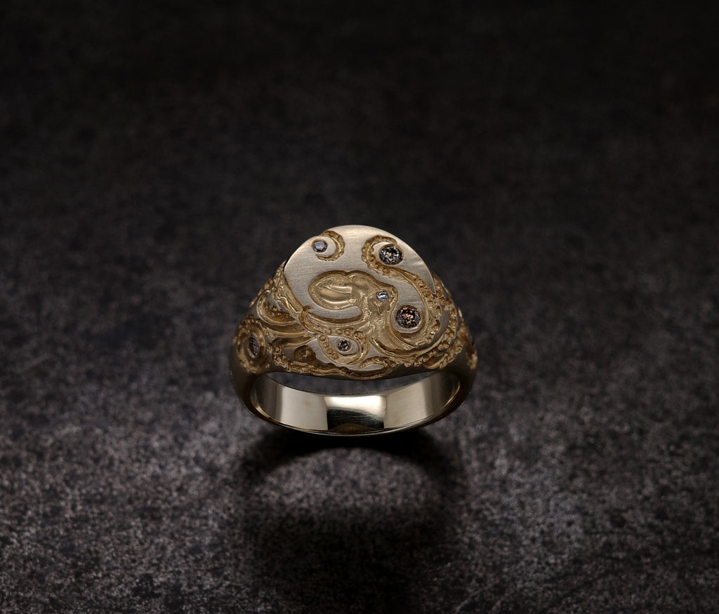 Mini Octopus Signet Ring featuring hand-engraved octopus design with rubies and diamonds on a silver band.