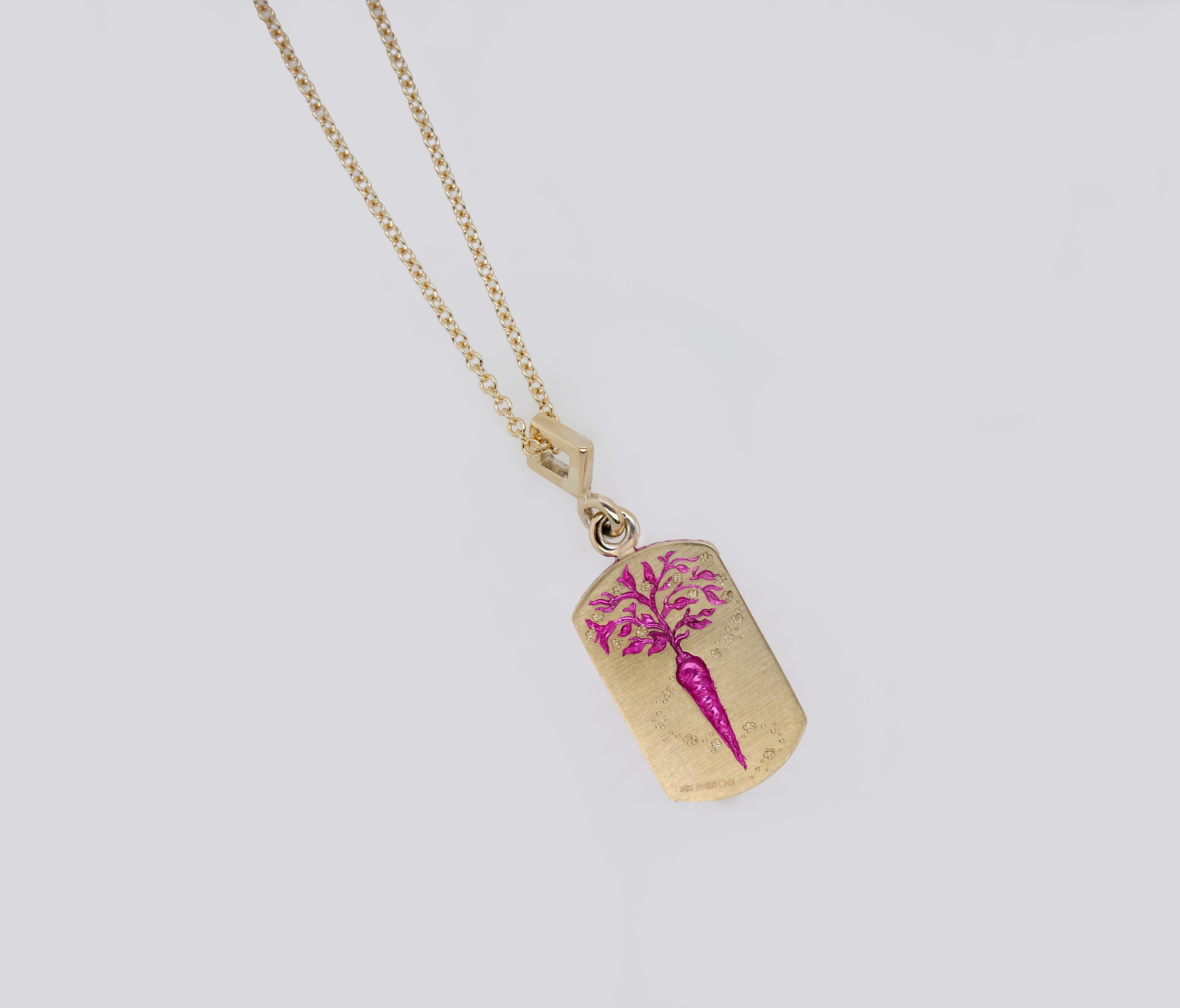 Gold ceramic-plated pendant with hand-engraved pink carrot design on an intricate chain necklace.