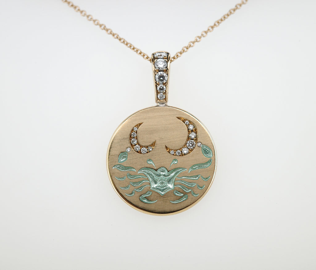 Round gold pendant featuring a crab design with diamond crescent moons and diamond-studded bale on a chain