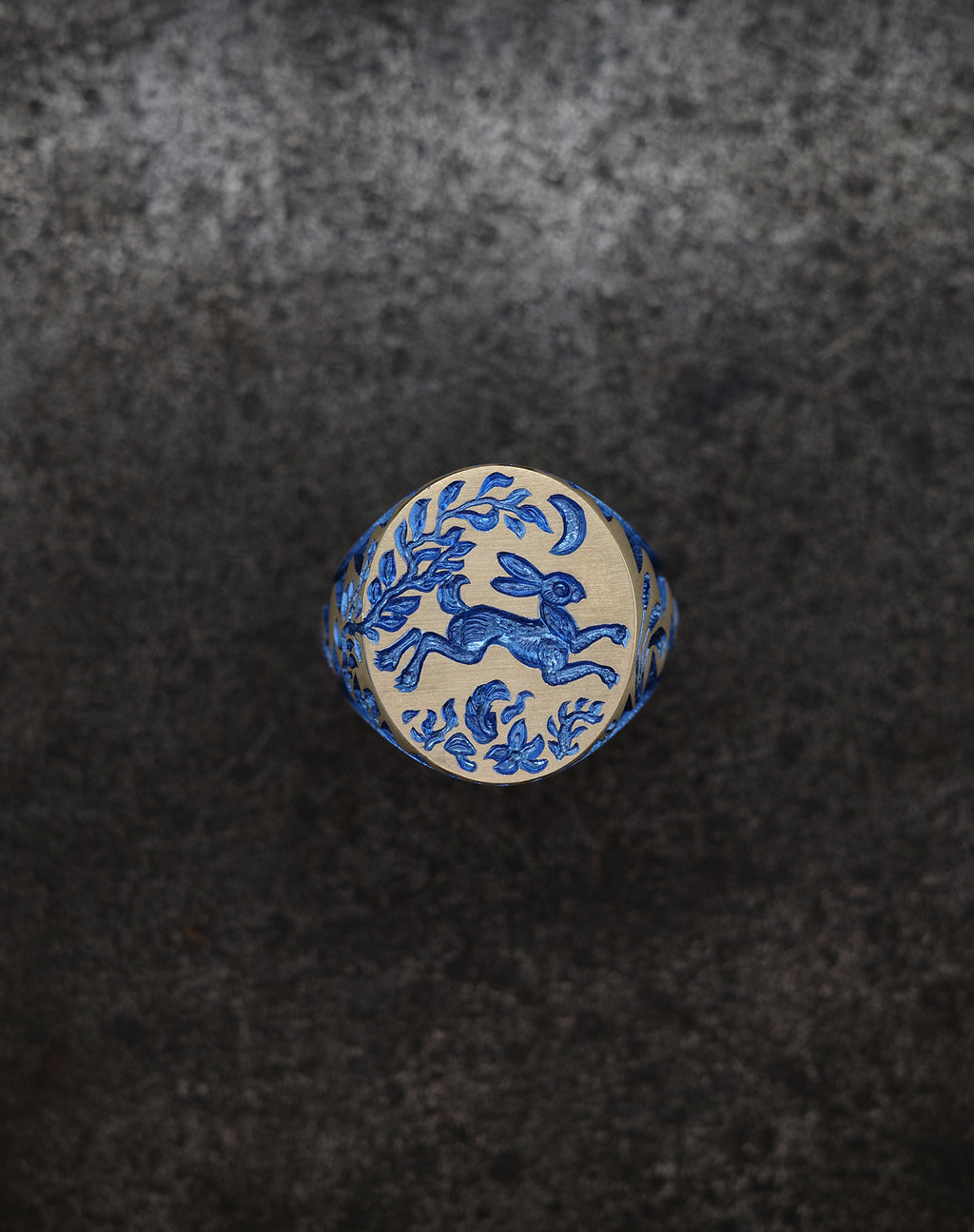 Hand engraved Hare & Trap signet ring in silver with blue detailing of a hare escaping under the moon and floral motifs