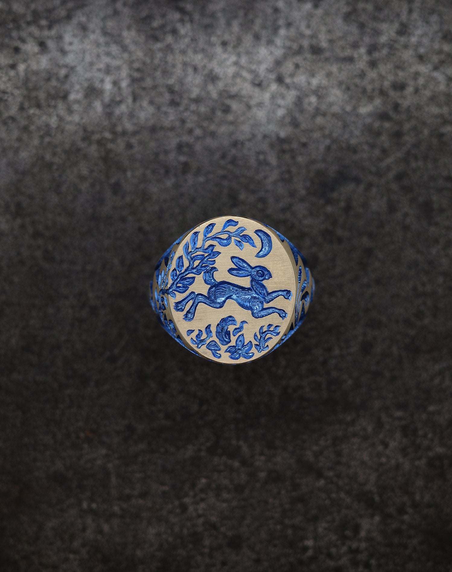 Hand engraved Hare & Trap signet ring in silver with blue detailing of a hare escaping under the moon and floral motifs