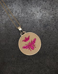 Gold Queen Bee Pendant with pink bee and crown engraving on textured black background