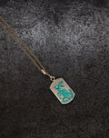 Pendant necklace with hand-engraved turquoise rabbit and foliage on a silver ceramic-plated background with gold chain