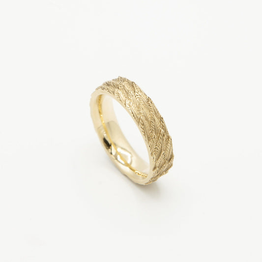 Castro Smith Jewelry Gold Feather Wedding Band Ring in White Background.