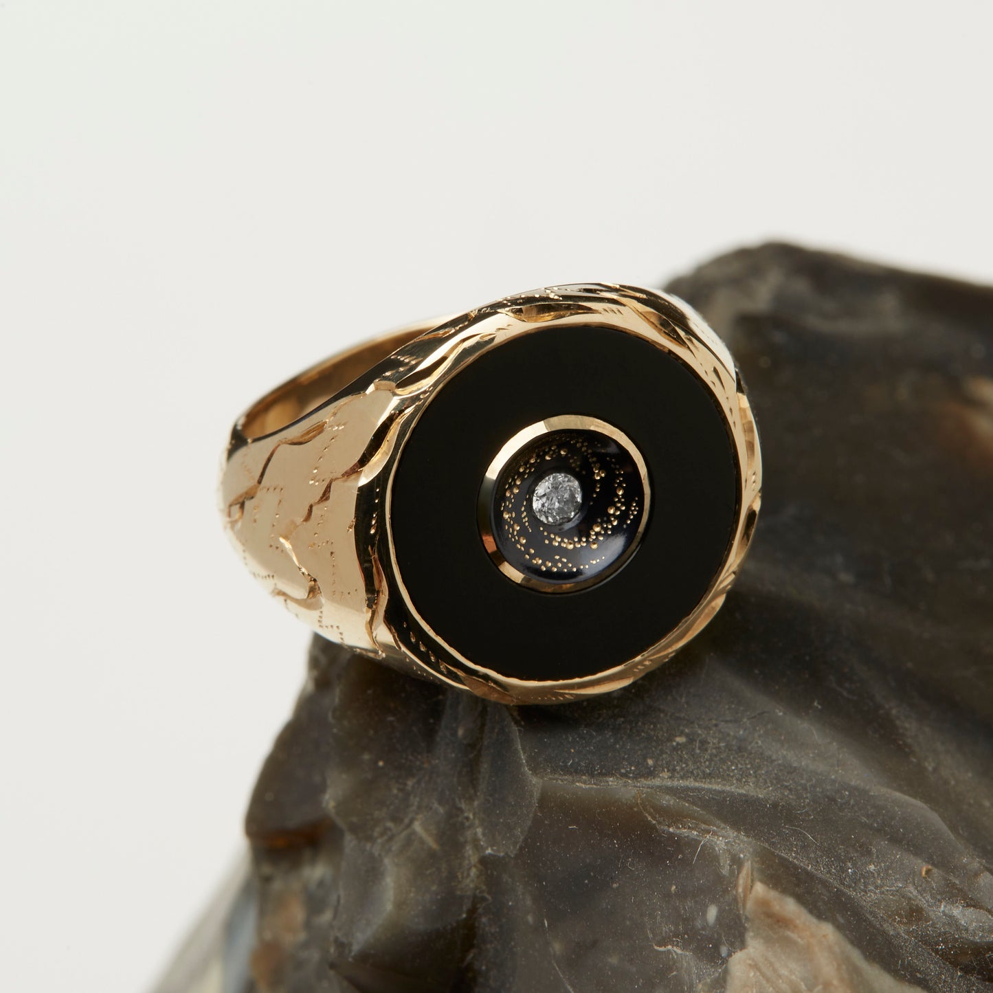 Castro Smith Jewelry Gold Oubliette Signet Ring with Onyx Around a Concave Galaxy with a Centre Diamond in Left Side View.