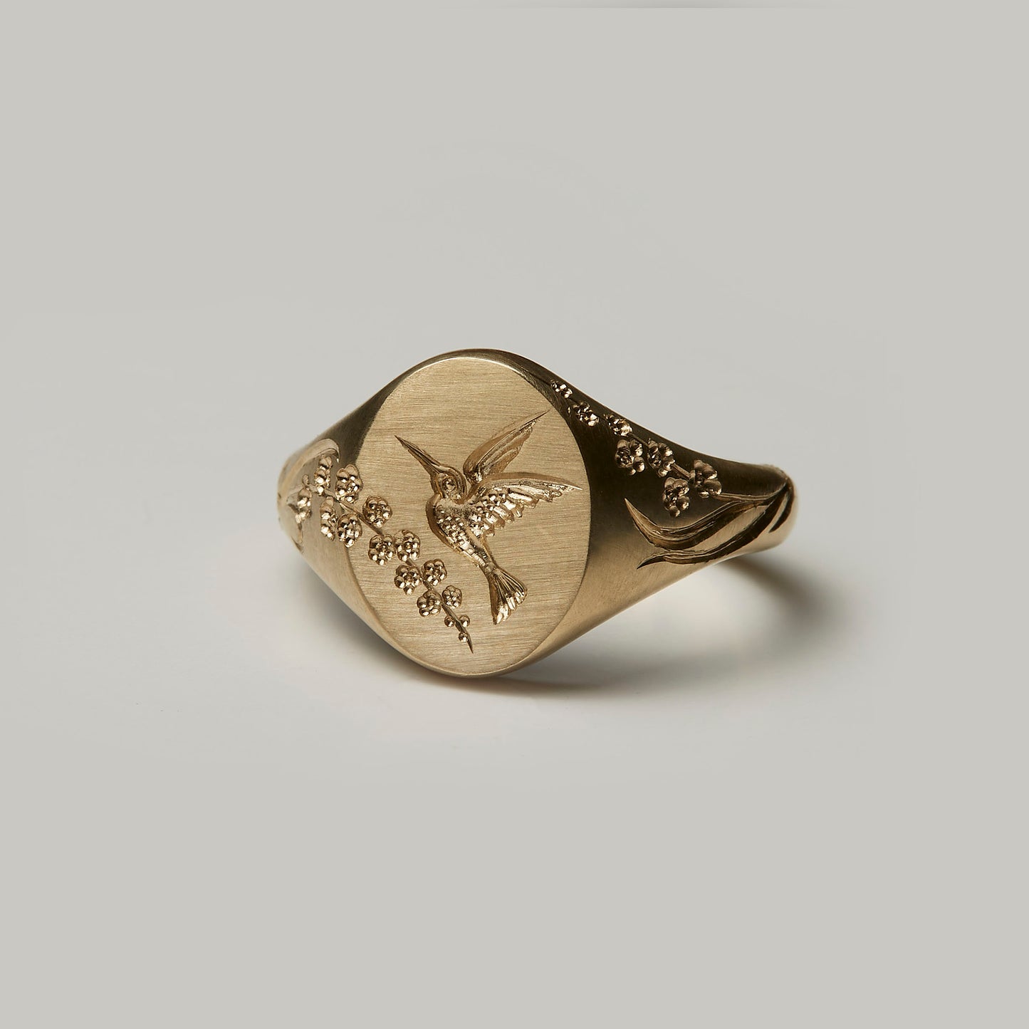Castro Smith Jewelry Gold Hummingbird Signet Ring with Engravings in Profile View.