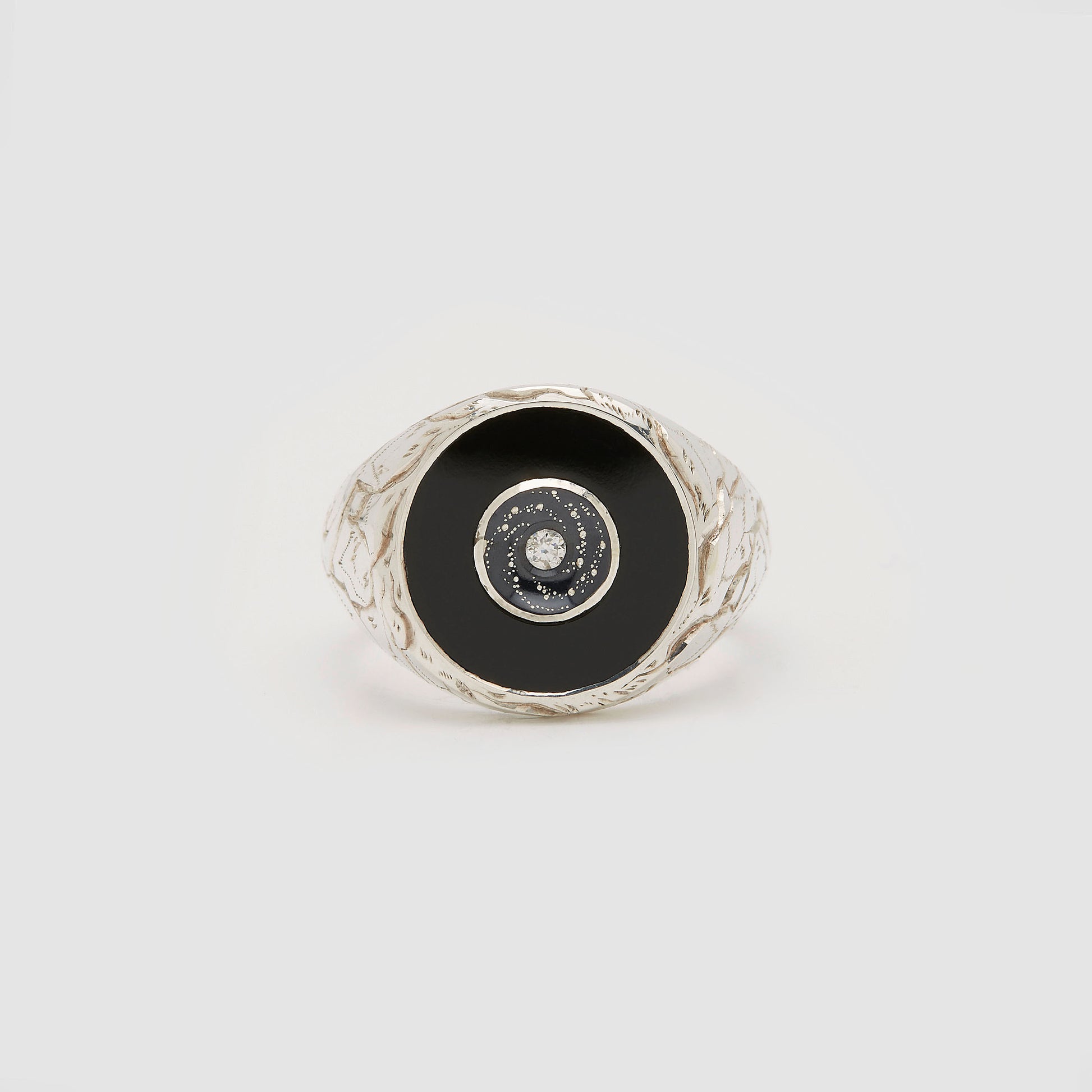 Castro Smith Jewelry Silver Oubliette Signet Ring with Onyx Around a Concave Galaxy with a Centre Diamond in Profile View.