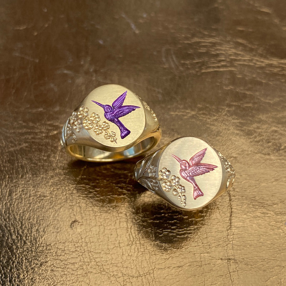 Castro Smith Jewelry Gold Hummingbird Signet Rings with Purple and Pearlescent Engravings.