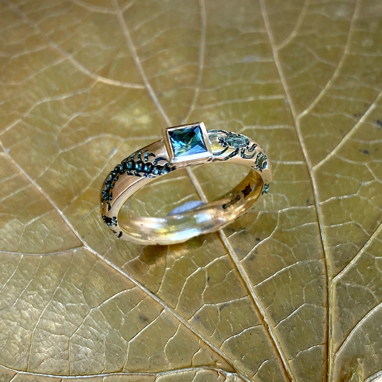 Castro Smith Jewelry Gold Undergrowth Ring with a Square Cut Sapphire and Slate Green Engravings in Top View.